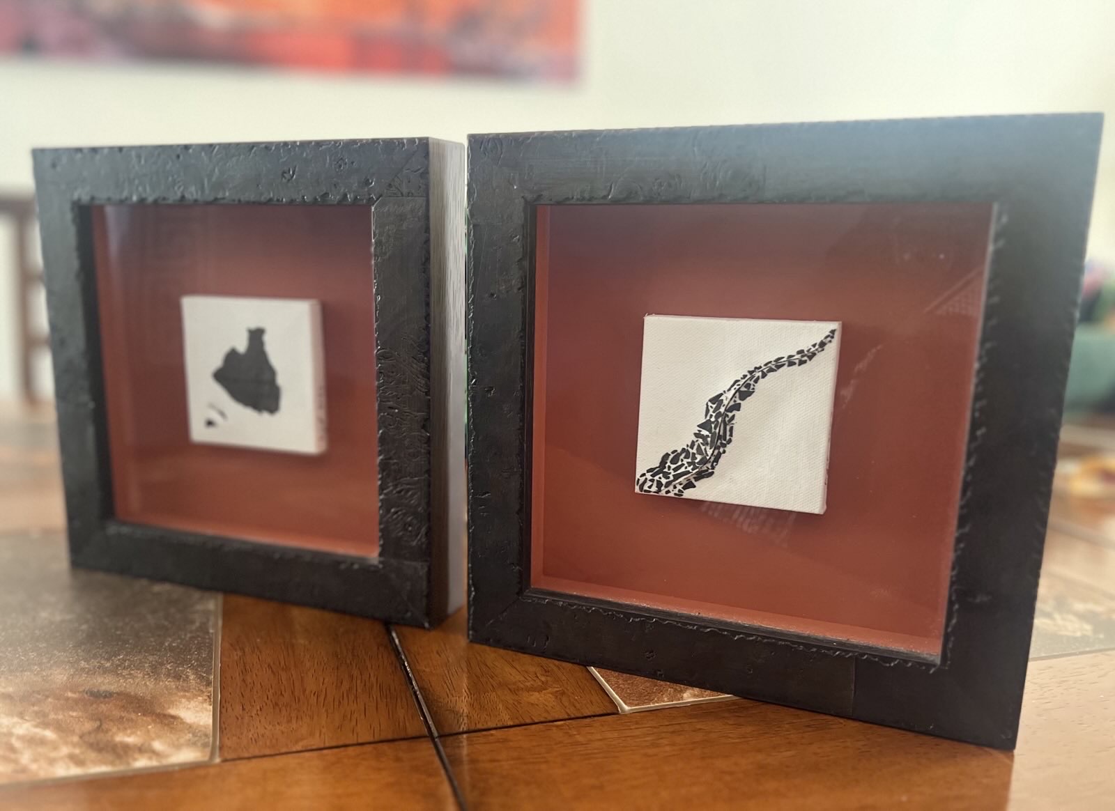 2 framed 3inx3in canvases collaged with embers from the Cameron Peak Fire