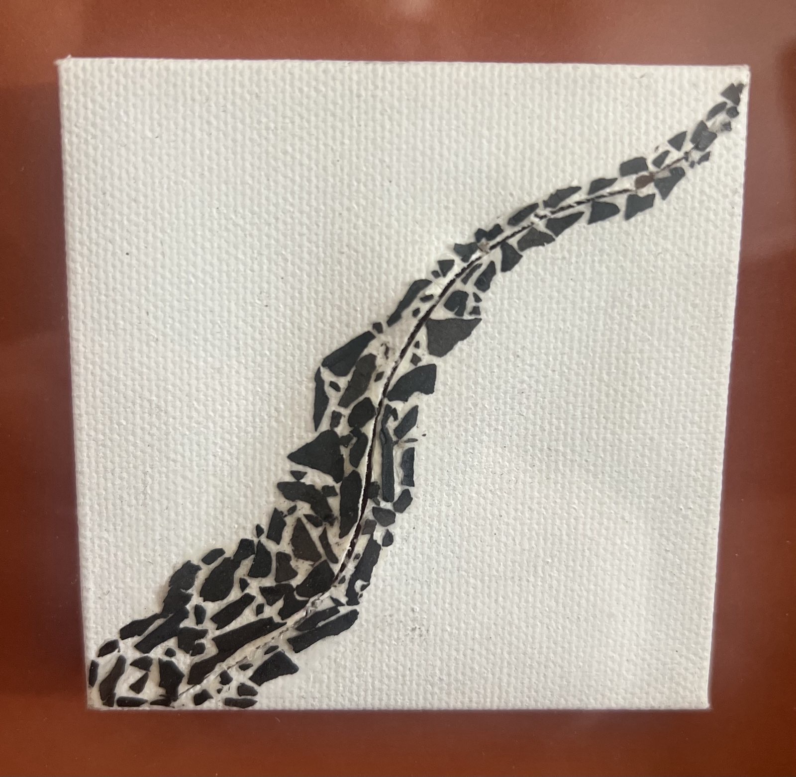 A collage of embers in a diagonal curve across a slit 3inx3in canvas